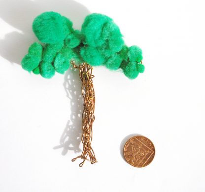aerial view of large tree badge shown next to 2 pence coin