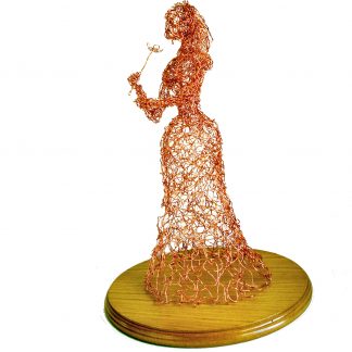 side view of wire lady with flower sculpture on round wooden base