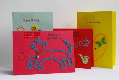 4 happy birthday card display includes dog playing with ball, large singular heart, vase with flowers and guitar music