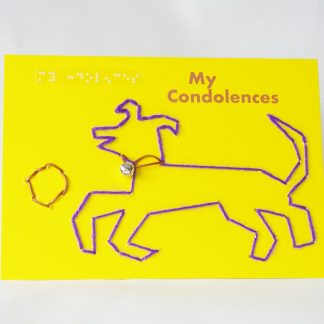 Purple sparkly dog with leather collar and silver bell audible, playing with leather ball on landscape yellow card